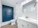 Updated bathroom featuring tiled shower with blue accent tiles, modern vanity, and fixtures at 1307 Jean Ct, Eustis, FL 32726