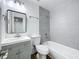 Updated bathroom with grey-tiled shower and tub, modern vanity, and fixtures at 1307 Jean Ct, Eustis, FL 32726