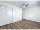 Bedroom features wood-look flooring, closet, ceiling fan, and white walls at 1307 Jean Ct, Eustis, FL 32726