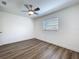 Cozy bedroom featuring a ceiling fan, gray flooring, and a bright window that fills the space with natural light at 1307 Jean Ct, Eustis, FL 32726