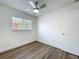 Bedroom features wood-look floors, ceiling fan, white walls and a window with natural light at 1307 Jean Ct, Eustis, FL 32726