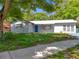 Charming single-story home featuring a freshly painted exterior, blue door, and well-maintained front lawn at 1307 Jean Ct, Eustis, FL 32726