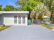 Wide driveway and side of the home, offering ample parking with an enclosed chain-link fence at 1307 Jean Ct, Eustis, FL 32726