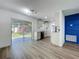 Bright kitchen featuring white cabinets, stainless steel appliances, and sliding glass doors to the backyard at 1307 Jean Ct, Eustis, FL 32726