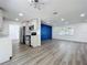 Modern kitchen with stainless steel appliances, white cabinetry, and an open view to the living area at 1307 Jean Ct, Eustis, FL 32726