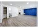 Open-concept space seamlessly connects the living room, bathroom, and kitchen areas with stylish gray flooring at 1307 Jean Ct, Eustis, FL 32726