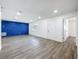 Spacious living room with modern gray flooring, a blue accent wall, and a bright, airy feel at 1307 Jean Ct, Eustis, FL 32726