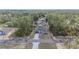 Wide aerial perspective highlighting the location of this modern home nestled among the mature trees of the surrounding area at 13419 Sw 77Th Ave, Ocala, FL 34473