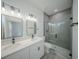 Modern bathroom with double vanity, glass-enclosed shower, and neutral finishes at 13419 Sw 77Th Ave, Ocala, FL 34473