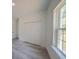 Bedroom features wood-look flooring, window with natural light, and a closet at 13419 Sw 77Th Ave, Ocala, FL 34473