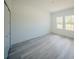 Bright bedroom with wood-look flooring, neutral walls, and ample natural light at 13419 Sw 77Th Ave, Ocala, FL 34473