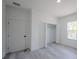 Bedroom with wood-look floors, closet, and bright window at 13419 Sw 77Th Ave, Ocala, FL 34473