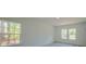 Bright bedroom with neutral walls, wood-look flooring, and well-lit windows at 13419 Sw 77Th Ave, Ocala, FL 34473
