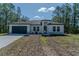 Charming one-story home with a two car garage, and meticulously landscaped front yard with mature trees at 13419 Sw 77Th Ave, Ocala, FL 34473