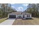 Stunning single-story home with a modern white exterior, two car garage, and well-maintained lawn at 13419 Sw 77Th Ave, Ocala, FL 34473