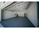 Spacious two-car garage featuring sealed concrete floor and freshly painted walls at 13419 Sw 77Th Ave, Ocala, FL 34473