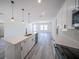 Bright kitchen featuring white cabinetry, stainless steel appliances, quartz counters and an open floorplan at 13419 Sw 77Th Ave, Ocala, FL 34473