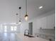 Bright kitchen featuring white cabinetry, stainless steel appliances, quartz counters, an island and pendant lighting at 13419 Sw 77Th Ave, Ocala, FL 34473