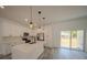 Modern kitchen features a quartz island, stainless appliances, and white cabinets at 13419 Sw 77Th Ave, Ocala, FL 34473