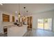 Modern kitchen features a quartz island, stainless appliances, and open cabinets at 13419 Sw 77Th Ave, Ocala, FL 34473