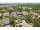 A beautiful home shown in an aerial view featuring a pool and surrounding serene lake views in a quiet neighborhood at 14781 Old Thicket Trce, Winter Garden, FL 34787