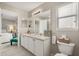 Well-lit bathroom features double sinks, a window, and an adjacent bedroom at 14781 Old Thicket Trce, Winter Garden, FL 34787