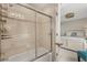Clean and bright bathroom featuring a shower-tub combo and open doorway to bedroom at 14781 Old Thicket Trce, Winter Garden, FL 34787