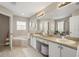 Bright bathroom featuring double sinks, a vanity area, and a separate soaking tub at 14781 Old Thicket Trce, Winter Garden, FL 34787