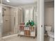 Modern bathroom with a glass-enclosed shower and stylish storage cabinet at 14781 Old Thicket Trce, Winter Garden, FL 34787