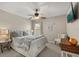 Cozy bedroom with soft colors, a decorative ceiling fan, and comfortable seating at 14781 Old Thicket Trce, Winter Garden, FL 34787