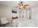 Serene bedroom with ceiling fan, a wall-mounted TV, and ensuite bathroom access at 14781 Old Thicket Trce, Winter Garden, FL 34787