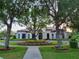 Stunning clubhouse with beautiful landscaping, mature trees, and inviting entrance at 14781 Old Thicket Trce, Winter Garden, FL 34787