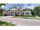 Beautiful clubhouse featuring classic architecture, manicured landscaping, and a welcoming entrance at 14781 Old Thicket Trce, Winter Garden, FL 34787