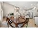 Open-concept dining area adjacent to the kitchen and living room, filled with natural light and modern finishes at 14781 Old Thicket Trce, Winter Garden, FL 34787