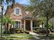 Charming two-story home with a landscaped yard, columns on the porch, and large windows at 14781 Old Thicket Trce, Winter Garden, FL 34787
