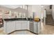 Corner kitchen showcasing stainless steel appliances, granite counters, white cabinets, and open access to dining area at 14781 Old Thicket Trce, Winter Garden, FL 34787