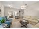 Inviting living room featuring stylish furnishings, neutral tones, and a seamless flow to other living spaces at 14781 Old Thicket Trce, Winter Garden, FL 34787