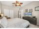 Serene primary bedroom featuring a ceiling fan, a walk-in closet, and an ensuite bathroom at 14781 Old Thicket Trce, Winter Garden, FL 34787