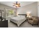 Comfortable primary bedroom offering ample natural light, neutral decor, and a ceiling fan at 14781 Old Thicket Trce, Winter Garden, FL 34787