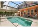 Backyard oasis featuring a sparkling pool, relaxing spa, and covered patio perfect for enjoying outdoor living at 14781 Old Thicket Trce, Winter Garden, FL 34787