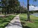 Scenic walking path lined with lush trees and landscaping in a peaceful, well-maintained community at 14781 Old Thicket Trce, Winter Garden, FL 34787
