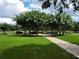 Serene walking path surrounded by lush green lawns and blooming trees at 14781 Old Thicket Trce, Winter Garden, FL 34787