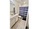 Bathroom with a white vanity, a shower-tub with a blue striped curtain, and tile flooring at 17148 Cagan Crossings Blvd, Clermont, FL 34714