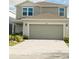 Two-story home with a gray exterior, a two-car garage, and well maintained landscaping at 17148 Cagan Crossings Blvd, Clermont, FL 34714