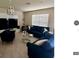 Bright living room features a large window for natural light and comfortable, stylish seating at 17148 Cagan Crossings Blvd, Clermont, FL 34714