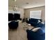 Comfortable living room with stylish blue furnishings, tile flooring, and ample natural light at 17148 Cagan Crossings Blvd, Clermont, FL 34714