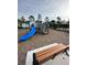 Community playground with a slide, climbing structures, and benches for relaxation at 17148 Cagan Crossings Blvd, Clermont, FL 34714