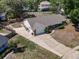 Aerial view of a single-Gathering home with a large driveway, lush greenery, and a fenced backyard at 1742 Willa Cir, Winter Park, FL 32792