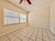 Bedroom featuring neutral paint, tile flooring, and natural light from a large window at 1742 Willa Cir, Winter Park, FL 32792