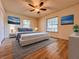A staged bedroom with hardwood floors and decorative artwork at 1742 Willa Cir, Winter Park, FL 32792